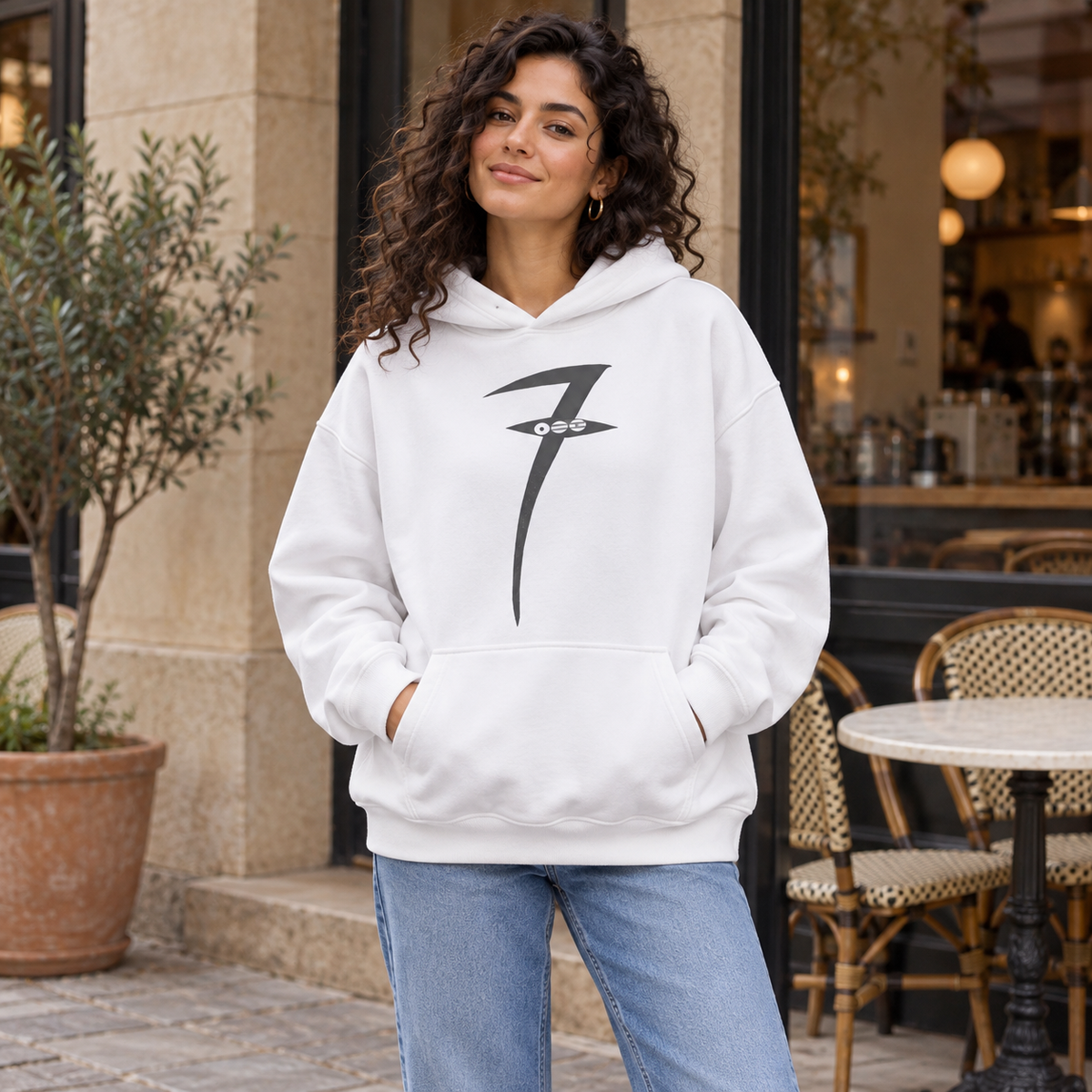 AI-generated styling visualisation — white hoodie front at a cafe