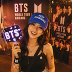 BTS fan wearing the blue Keep Swimming cap at a concert-inspired event