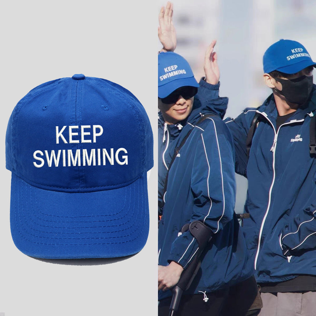 Keep Swimming blue cap shown with a BTS-inspired fan style reference