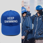 Keep Swimming blue cap shown with a BTS-inspired fan style reference